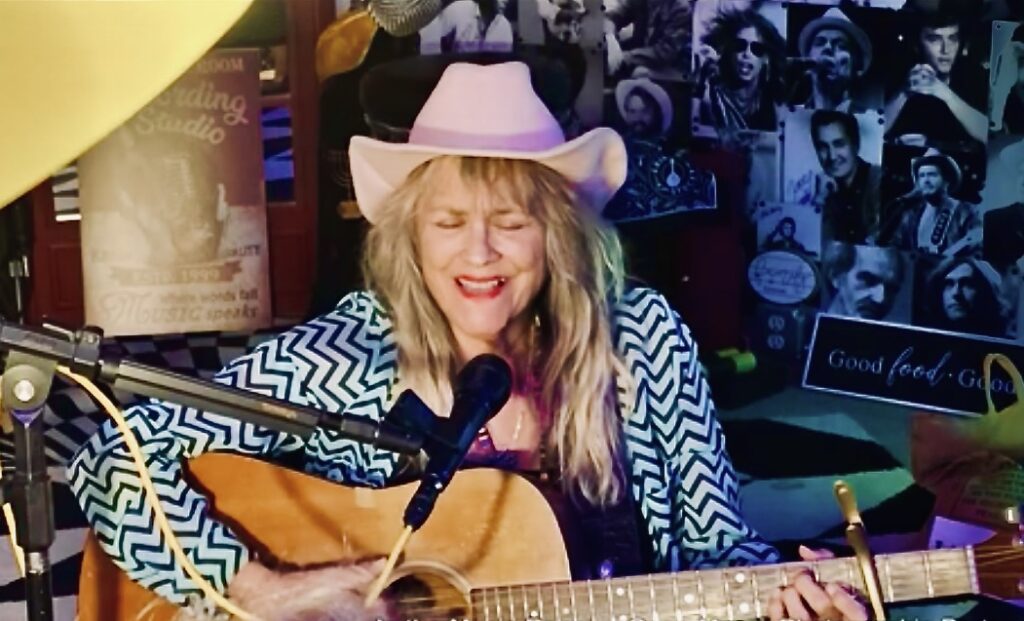 Jerialice Ars performing with acoustic guitar