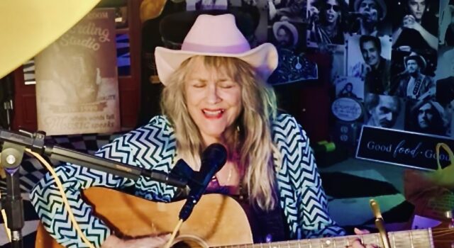 Jerialice Ars performing with acoustic guitar
