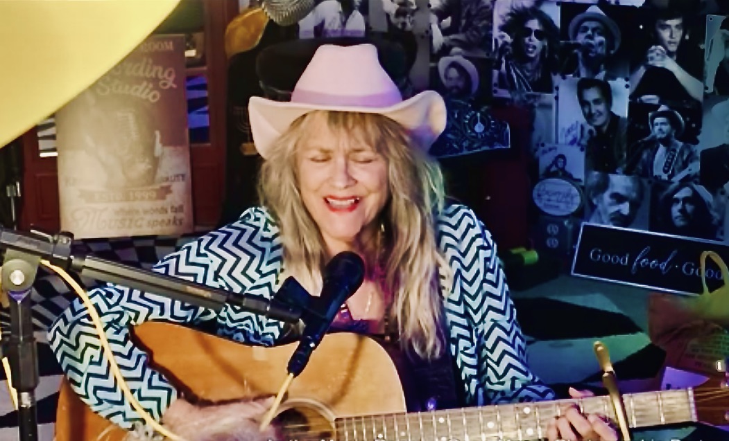 Jerialice Ars performing with acoustic guitar