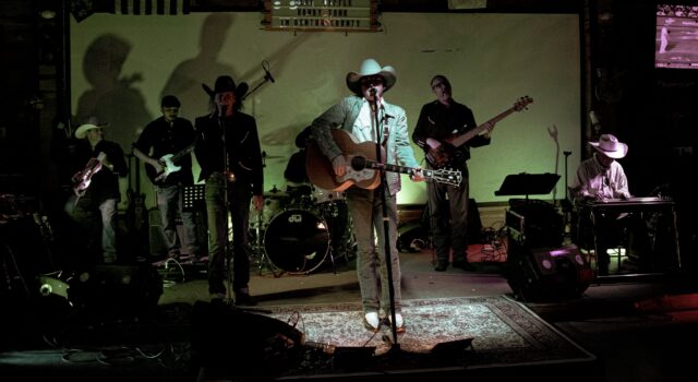 Supplied live photo used as a link to the full-band video; not a video still.